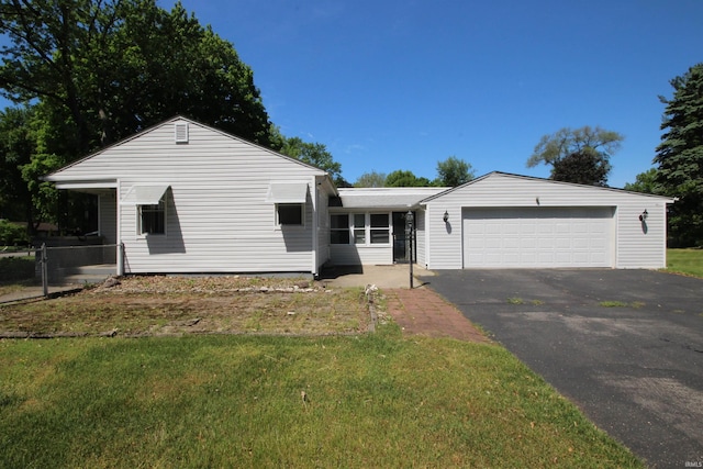 19511 Eaton Ave, South Bend, IN 46637 - ranch-style house featuring asphalt driveway, a garage, and a front lawn