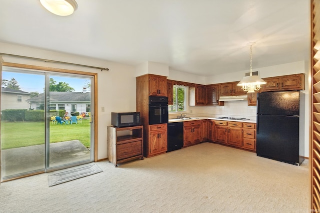 928 Hollyhill Dr, Fort Wayne, IN 46819 - kitchen featuring black appliances, under cabinet range hood, light countertops, light carpet, and decorative light fixtures