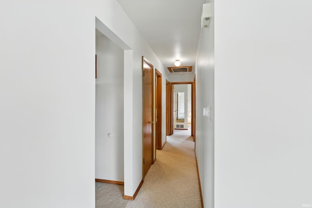 928 Hollyhill Dr, Fort Wayne, IN 46819 - hallway featuring light carpet and baseboards