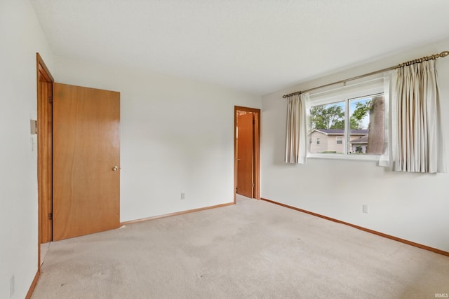 928 Hollyhill Dr, Fort Wayne, IN 46819 - spare room featuring baseboards and light colored carpet