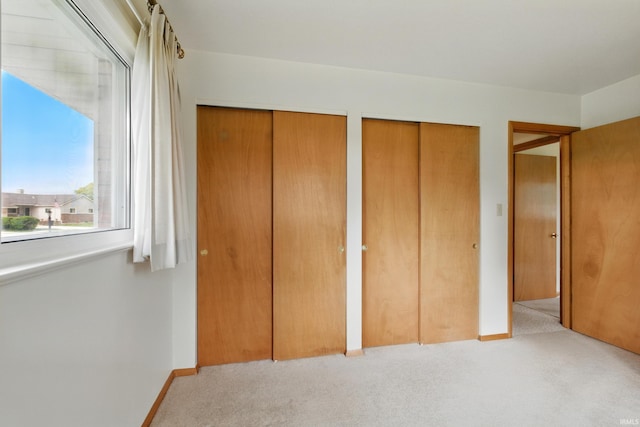 928 Hollyhill Dr, Fort Wayne, IN 46819 - unfurnished bedroom featuring carpet, two closets, and baseboards
