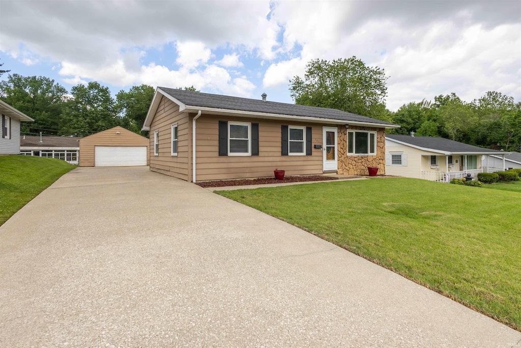 121 W Berkeley Ave, Evansville, IN 47710 - view of front facade featuring an outbuilding, a detached garage, a front yard, and stone siding