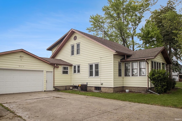 402 W Waterford St, Wakarusa, IN 46573 - view of home's exterior with concrete driveway, a garage, and roof with shingles