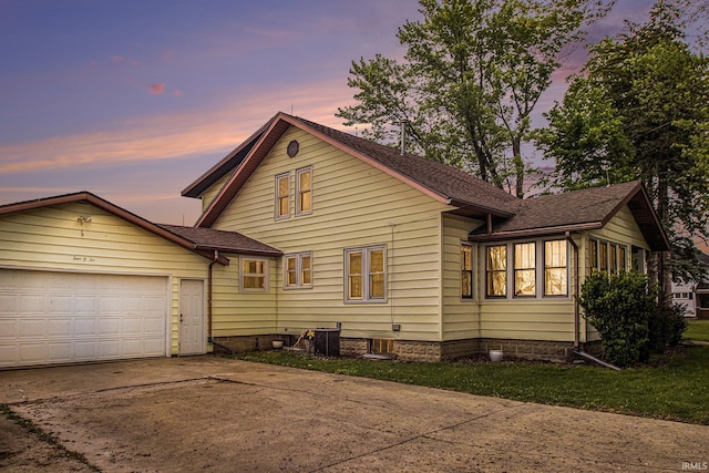 402 W Waterford St, Wakarusa, IN 46573 - view of front facade featuring concrete driveway, an attached garage, and roof with shingles
