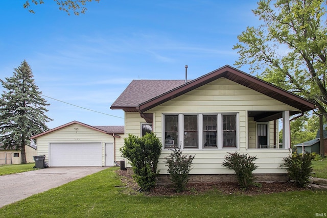 402 W Waterford St, Wakarusa, IN 46573 - view of front of house featuring a front lawn, concrete driveway, roof with shingles, and an attached garage