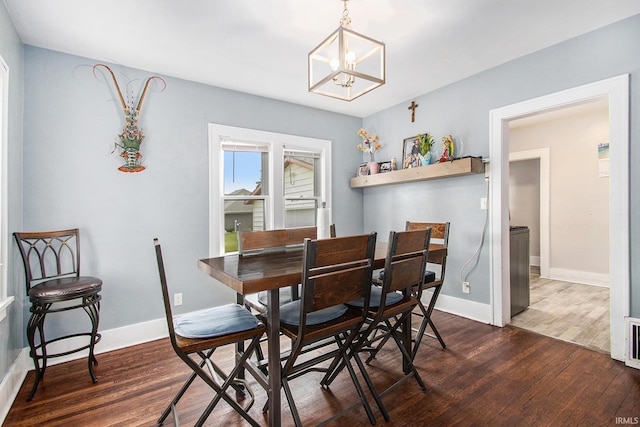 402 W Waterford St, Wakarusa, IN 46573 - dining space featuring a chandelier, wood finished floors, and baseboards