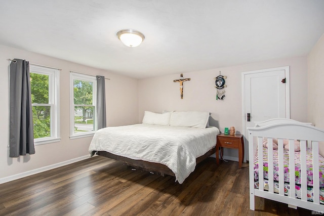402 W Waterford St, Wakarusa, IN 46573 - bedroom with wood finished floors and baseboards