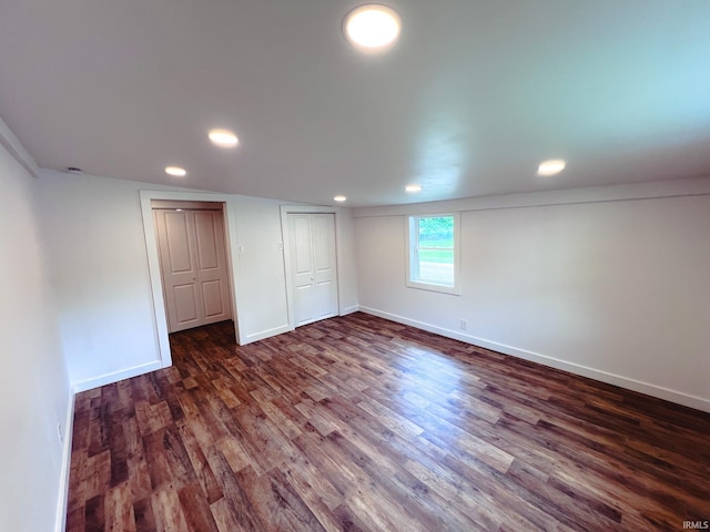 202 E Vine St, Mitchell, IN 47446 - unfurnished bedroom featuring dark wood-style floors, baseboards, recessed lighting, and a closet