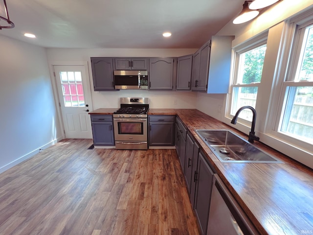 202 E Vine St, Mitchell, IN 47446 - kitchen with stainless steel appliances, wooden counters, a sink, plenty of natural light, and recessed lighting