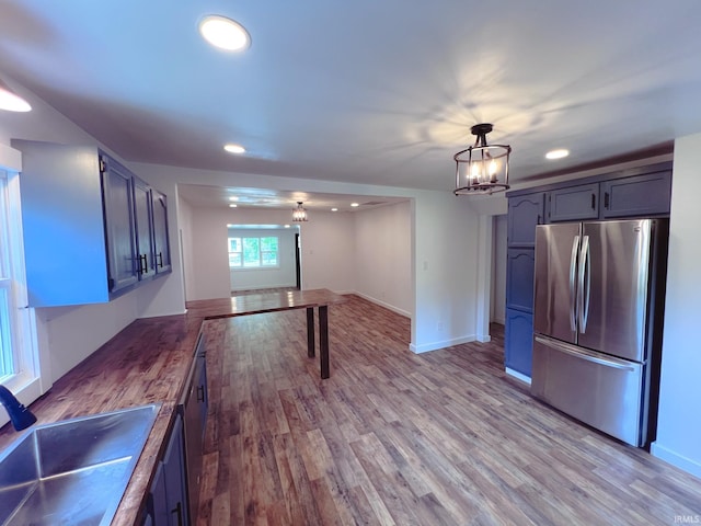 202 E Vine St, Mitchell, IN 47446 - kitchen featuring freestanding refrigerator, a chandelier, a sink, recessed lighting, and wood finished floors