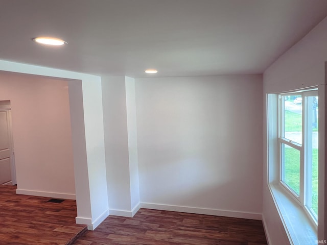 202 E Vine St, Mitchell, IN 47446 - empty room featuring healthy amount of natural light, wood finished floors, recessed lighting, and baseboards