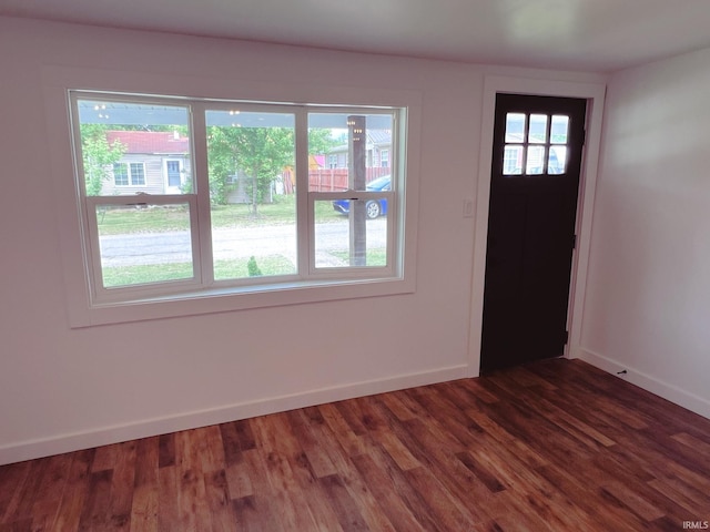 202 E Vine St, Mitchell, IN 47446 - entrance foyer with dark wood-type flooring and baseboards