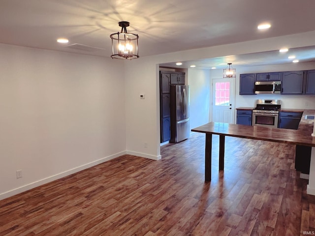 202 E Vine St, Mitchell, IN 47446 - kitchen featuring stainless steel appliances, dark wood-style flooring, recessed lighting, baseboards, and hanging light fixtures