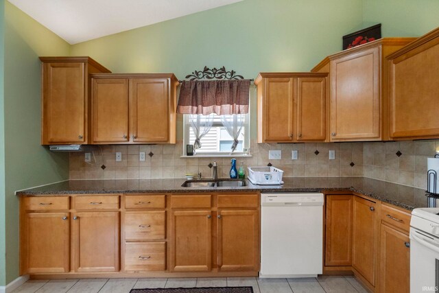 354 Kettle Cir, Lafayette, IN 47905 - kitchen with white dishwasher, a sink, dark stone counters, backsplash, and light tile patterned floors