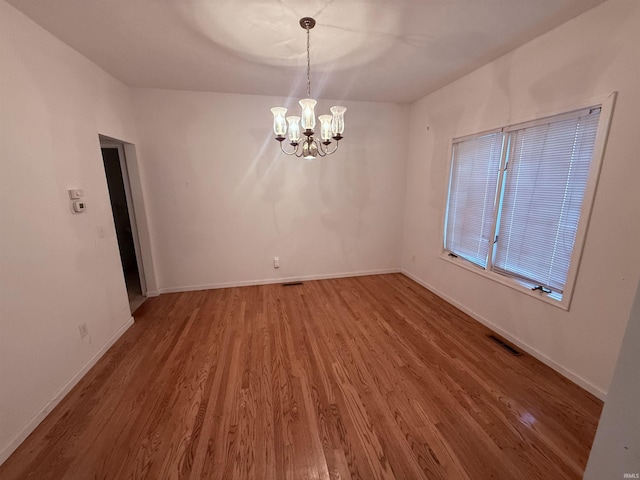 53172 Bracken Fern Dr, South Bend, IN 46637 - unfurnished room featuring wood finished floors, a chandelier, and baseboards