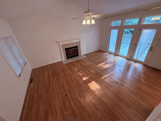 53172 Bracken Fern Dr, South Bend, IN 46637 - unfurnished living room featuring light wood-style floors, a fireplace, ceiling fan, lofted ceiling, and baseboards