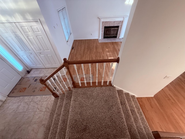 53172 Bracken Fern Dr, South Bend, IN 46637 - staircase featuring a high end fireplace, baseboards, and wood finished floors