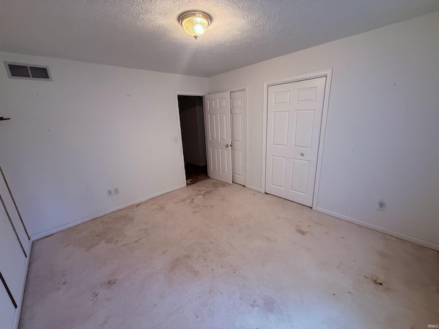 53172 Bracken Fern Dr, South Bend, IN 46637 - unfurnished bedroom featuring multiple closets, a textured ceiling, and baseboards