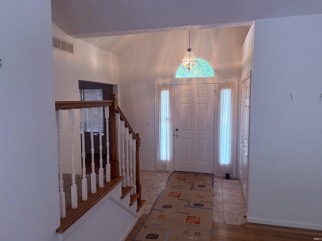 53172 Bracken Fern Dr, South Bend, IN 46637 - foyer with lofted ceiling, stairway, and baseboards
