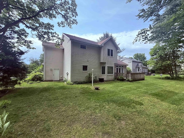 53172 Bracken Fern Dr, South Bend, IN 46637 - back of house featuring a yard, a wooden deck, and roof with shingles