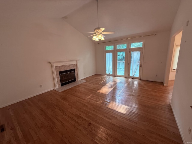 53172 Bracken Fern Dr, South Bend, IN 46637 - unfurnished living room featuring lofted ceiling, wood finished floors, a premium fireplace, ceiling fan, and baseboards