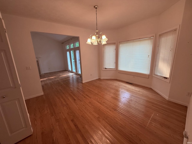 53172 Bracken Fern Dr, South Bend, IN 46637 - spare room with wood finished floors, a chandelier, baseboards, and vaulted ceiling