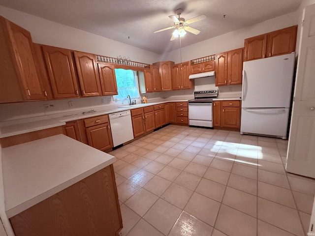 53172 Bracken Fern Dr, South Bend, IN 46637 - kitchen featuring white appliances, under cabinet range hood, a sink, light countertops, and light tile patterned flooring
