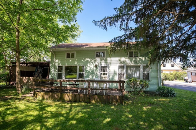 401 S Plymouth St, Culver, IN 46511 - back of house featuring a lawn and a deck