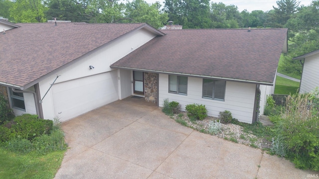 604 W Soutar Dr, Bloomington, IN 47403 - view of front of property with roof with shingles, concrete driveway, an attached garage, and a chimney