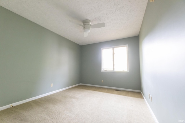 604 W Soutar Dr, Bloomington, IN 47403 - unfurnished room featuring ceiling fan, light carpet, a textured ceiling, and baseboards