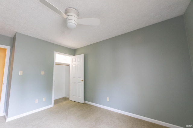 604 W Soutar Dr, Bloomington, IN 47403 - unfurnished bedroom featuring light colored carpet, baseboards, a ceiling fan, and a textured ceiling