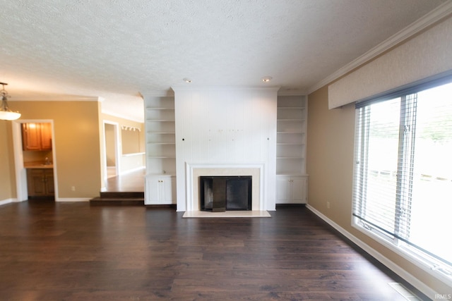 604 W Soutar Dr, Bloomington, IN 47403 - unfurnished living room with ornamental molding, baseboards, dark wood-style flooring, a glass covered fireplace, and a textured ceiling