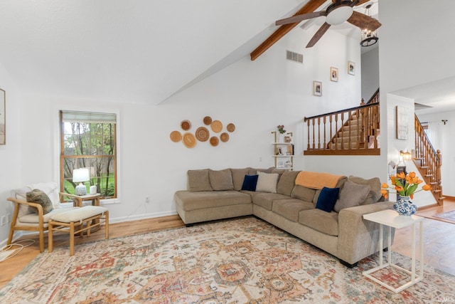15025 Water Oak Pl, Huntertown, IN 46748 - living room featuring wood finished floors, stairway, a ceiling fan, beam ceiling, and high vaulted ceiling