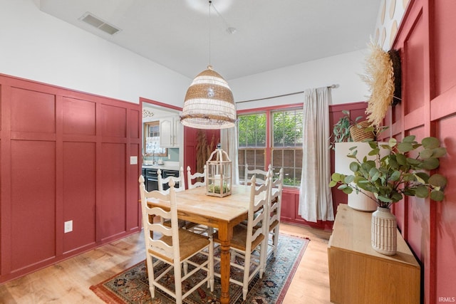 15025 Water Oak Pl, Huntertown, IN 46748 - dining space with light wood-style flooring and a decorative wall