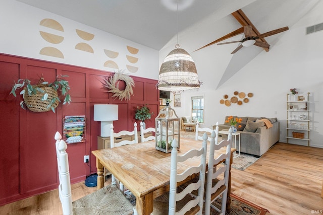 15025 Water Oak Pl, Huntertown, IN 46748 - dining area featuring a decorative wall, light wood-style flooring, ceiling fan, a wainscoted wall, and a chandelier