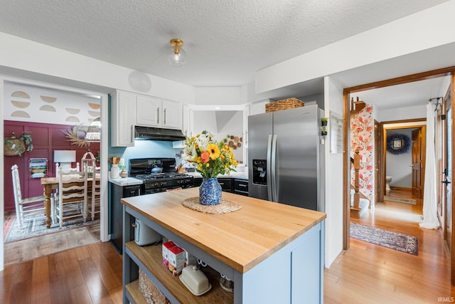 15025 Water Oak Pl, Huntertown, IN 46748 - kitchen featuring stainless steel fridge with ice dispenser, under cabinet range hood, butcher block countertops, white cabinets, and light wood-type flooring