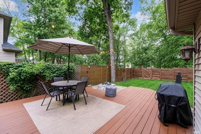 15025 Water Oak Pl, Huntertown, IN 46748 - wooden terrace with a fenced backyard, outdoor dining area, area for grilling, and view of wooded area