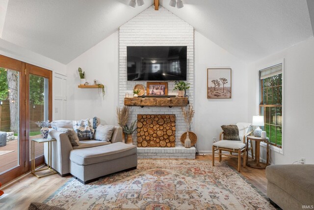 15025 Water Oak Pl, Huntertown, IN 46748 - living area featuring wood finished floors, a fireplace, lofted ceiling, healthy amount of natural light, and a ceiling fan