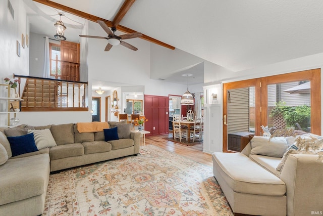 15025 Water Oak Pl, Huntertown, IN 46748 - living area featuring wood finished floors, high vaulted ceiling, ceiling fan, beamed ceiling, and stairs