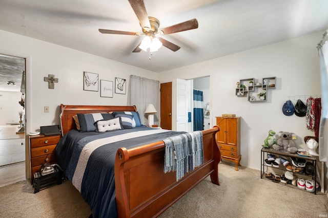 3106 W Brook Dr, Muncie, IN 47304 - bedroom with light colored carpet, ceiling fan, and connected bathroom