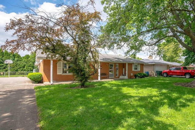 3106 W Brook Dr, Muncie, IN 47304 - ranch-style home with brick siding, an attached garage, a front lawn, a chimney, and driveway