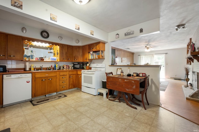 3106 W Brook Dr, Muncie, IN 47304 - kitchen featuring white appliances, open shelves, brown cabinets, a sink, and light flooring