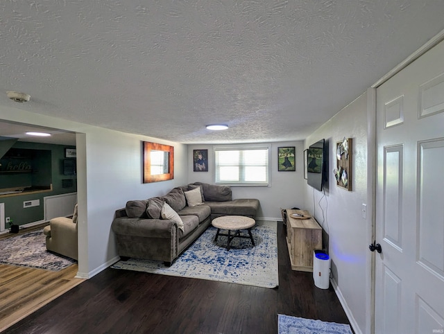 1406 N 800 E, Greentown, IN 46936 - living area with a textured ceiling, wood finished floors, and baseboards