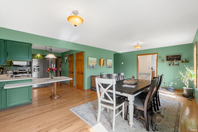 2395 State Road 427th Hwy, Waterloo, IN 46793 - dining space with light wood-style floors and a textured ceiling