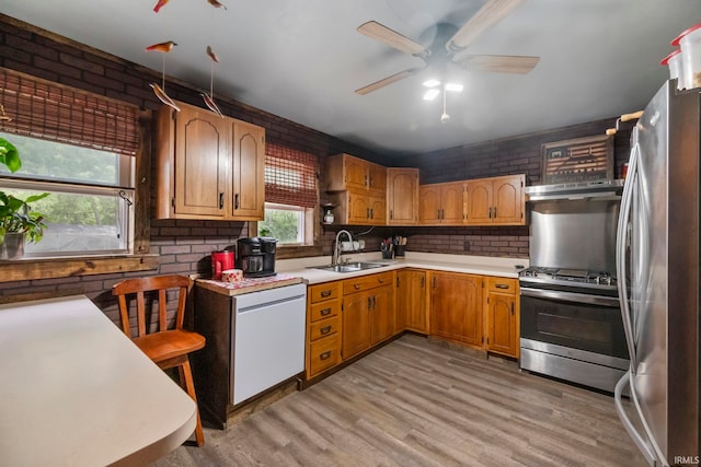 2526 S Airport Rd, Monticello, IN 47960 - kitchen featuring a sink, stainless steel appliances, a ceiling fan, under cabinet range hood, and light wood-type flooring