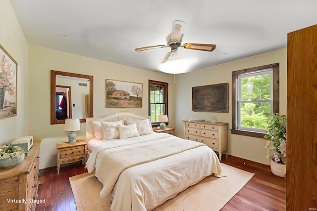 2526 S Airport Rd, Monticello, IN 47960 - bedroom featuring dark wood finished floors, baseboards, and a ceiling fan