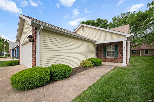 511 Westview Cir, West Lafayette, IN 47906 - view of home's exterior with brick siding, a yard, concrete driveway, and an attached garage