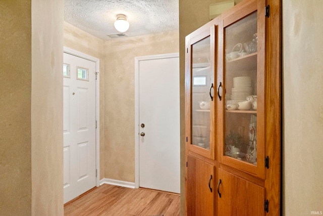 511 Westview Cir, West Lafayette, IN 47906 - foyer entrance featuring light wood-style flooring, a textured ceiling, and baseboards
