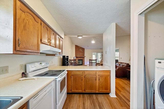 511 Westview Cir, West Lafayette, IN 47906 - kitchen with under cabinet range hood, white appliances, light wood-type flooring, light countertops, and a fireplace