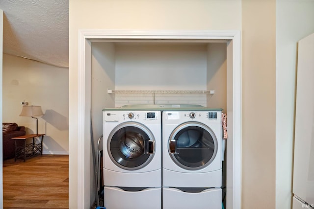 511 Westview Cir, West Lafayette, IN 47906 - laundry room featuring washer and dryer, wood finished floors, and baseboards